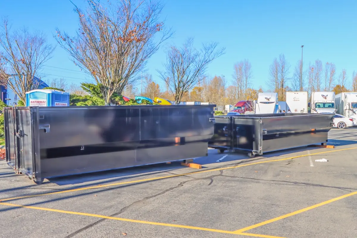 Professional dumpster rental service with roll-off container on residential driveway in Bensley